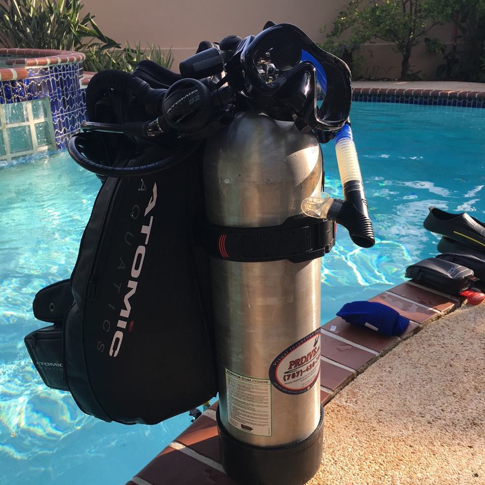 A BCD and cylinder set up by the pool