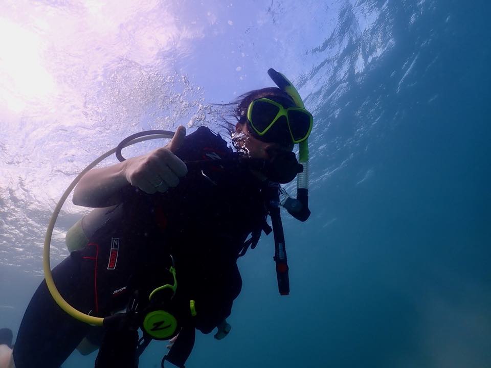 A diver near the surface giving the OK