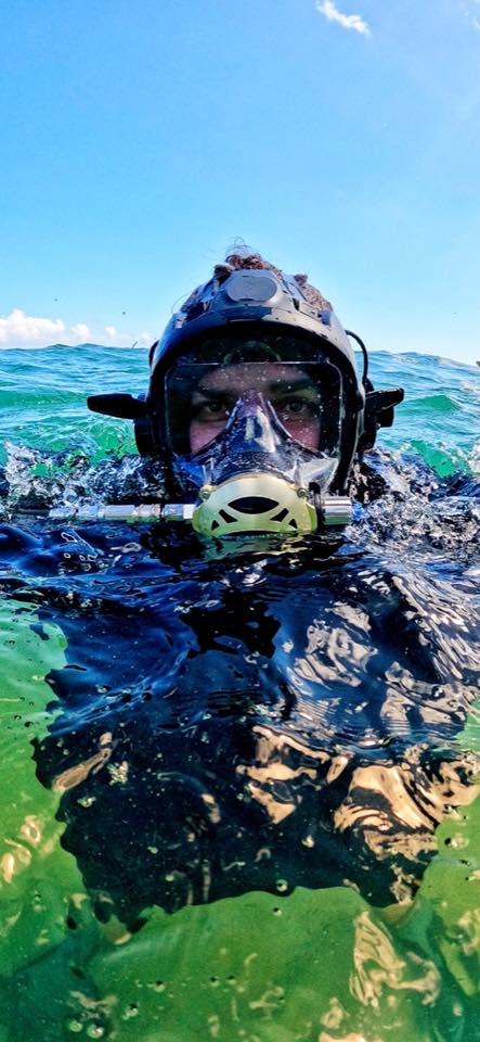 A diver at the surface wearing a full face mask