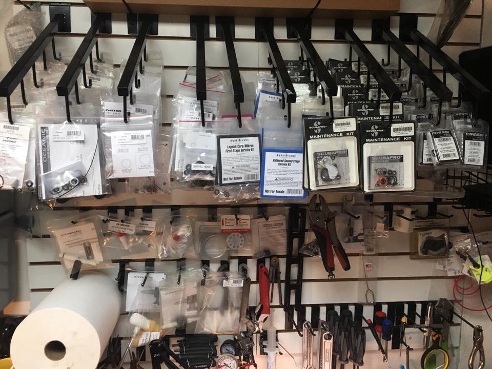 Wall of service kits and parts at the PR Dive shop