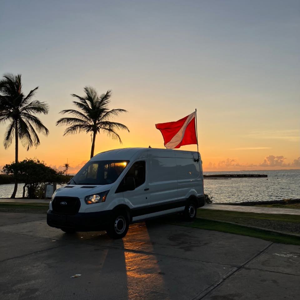 The PR Dive van with a dive flag at sunset