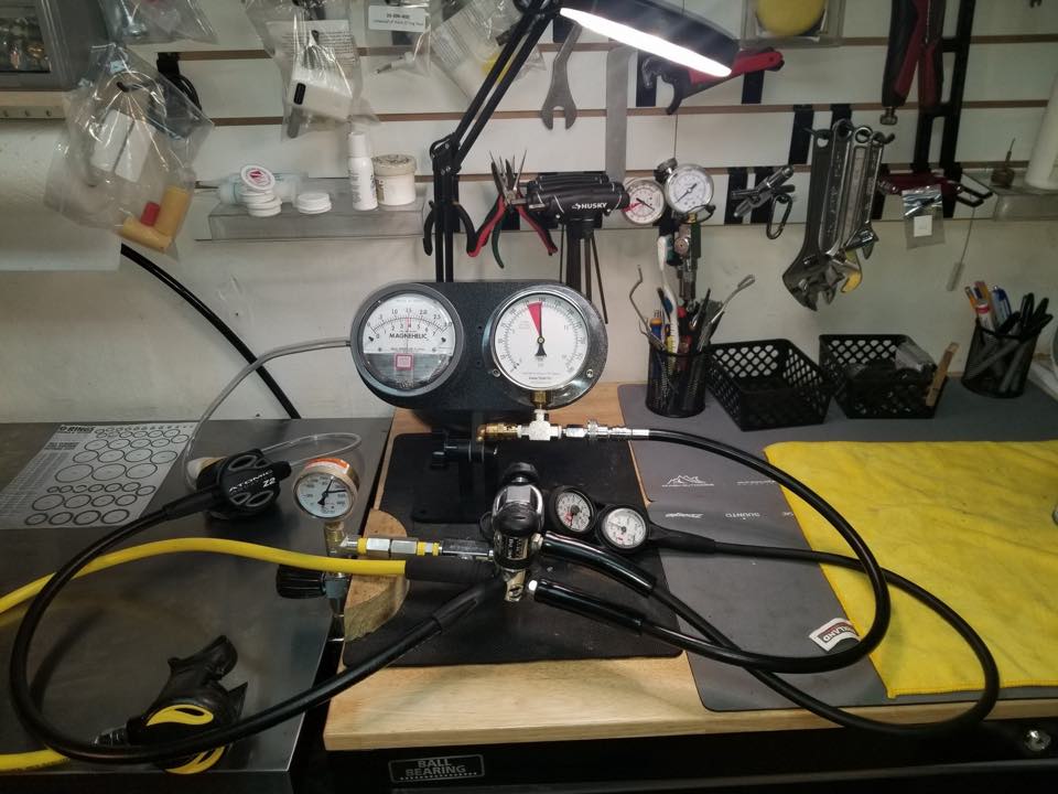 Regulator on the test bench at the PR Dive service area, with gauges and tools