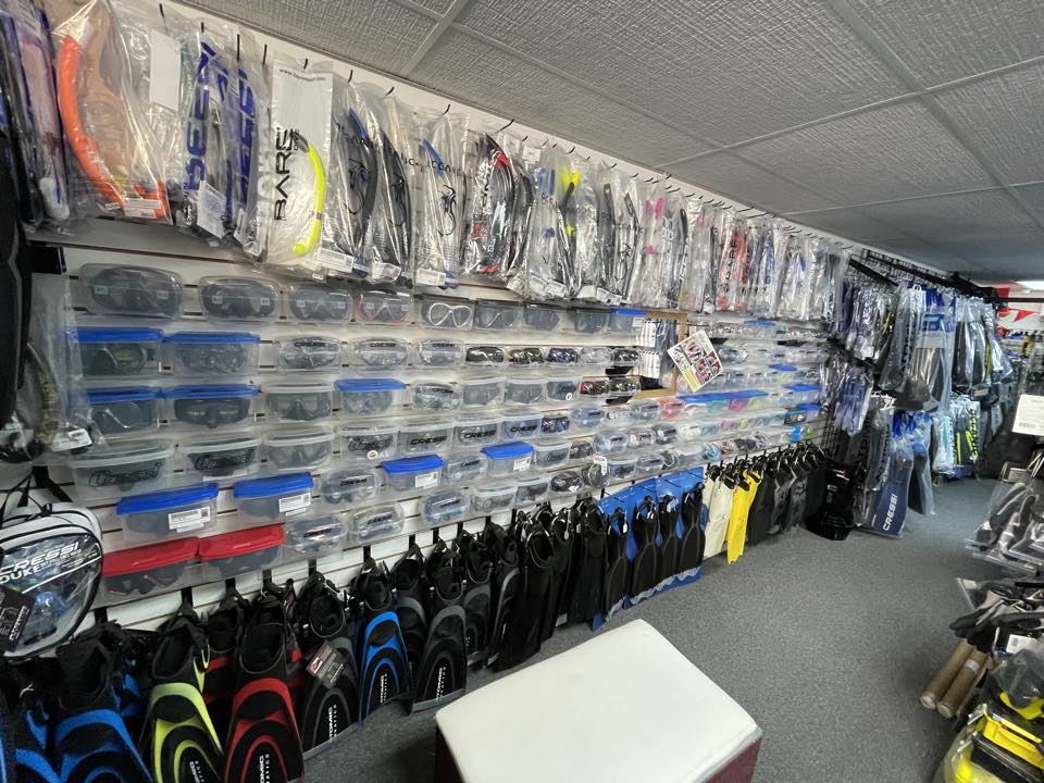 The wall of masks, snorkels and fins at PR Dive