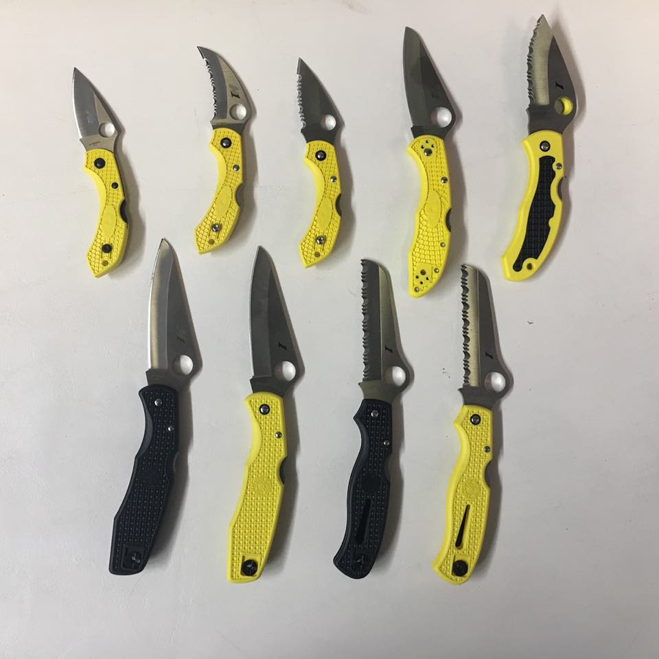 Yellow Spyderco dive knives lined up