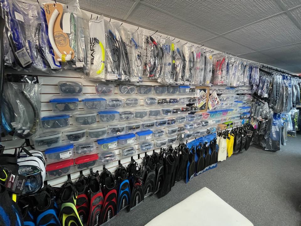 Masks, snorkels and fins displayed on the slatwall at PR Dive