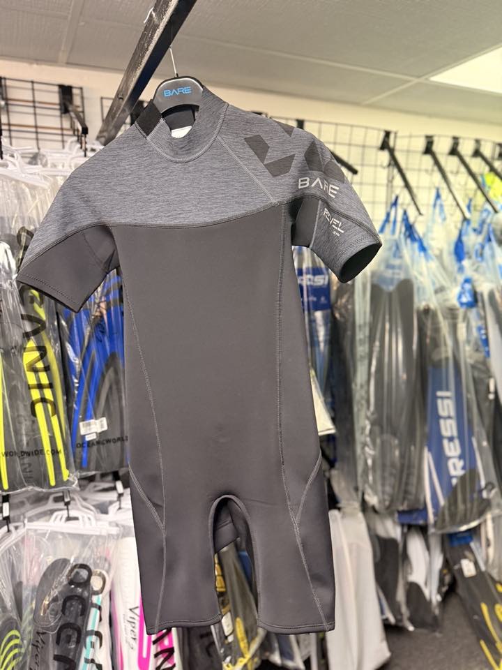 A shorty wetsuit on a hanger in the shop